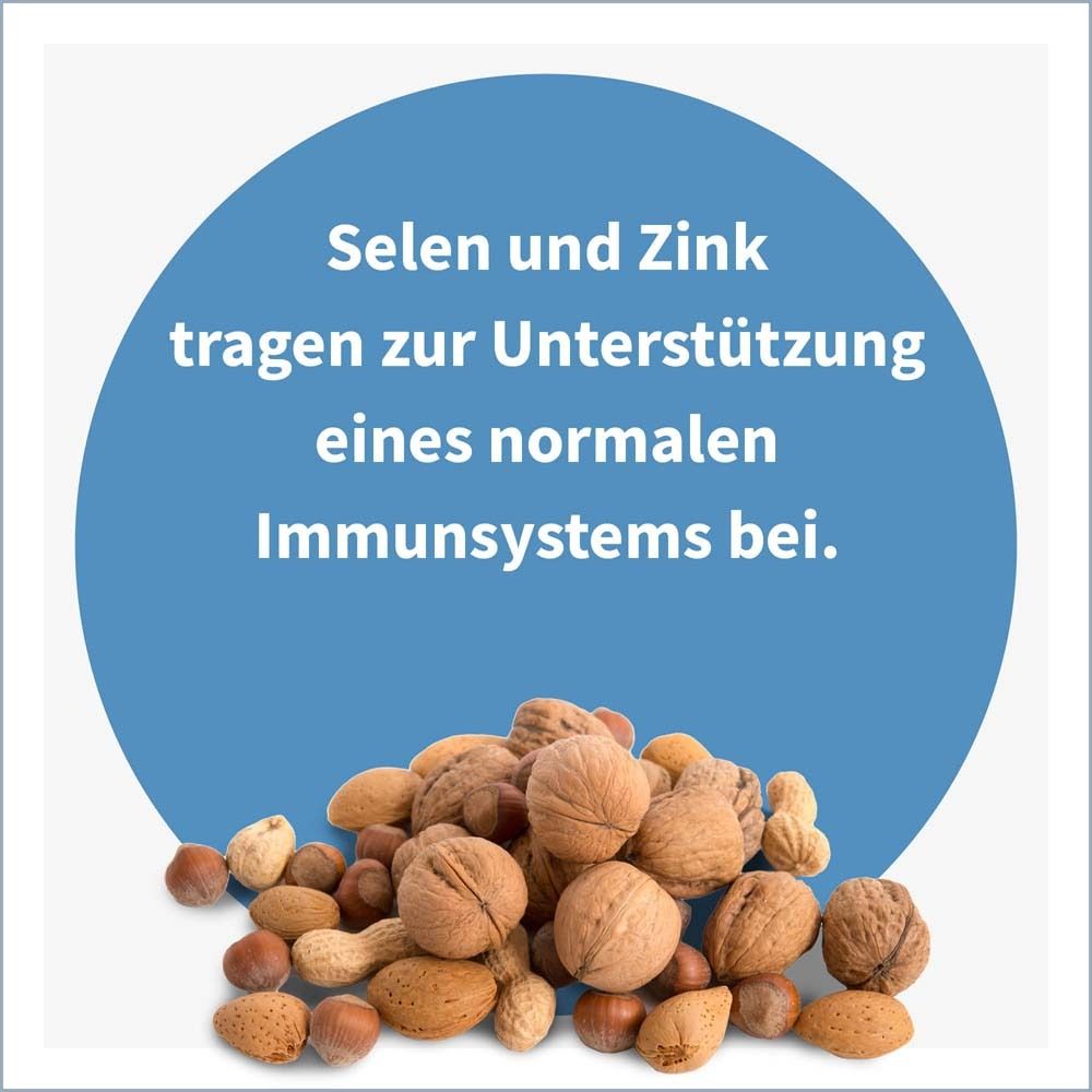 Blauer Kreis mit Text: Selen und Zink tragen zur Unterstützung eines normalen Immunsystems bei. Nüsse.