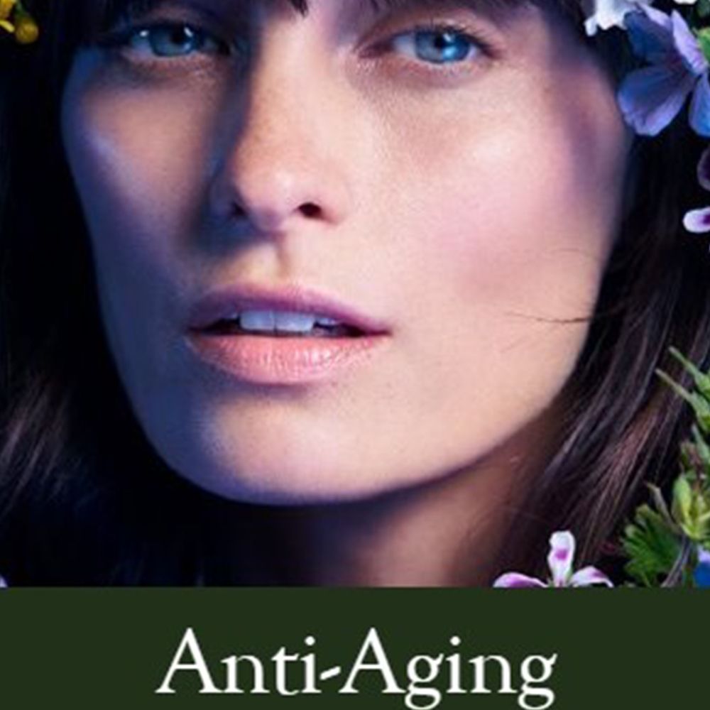 Gesicht einer Frau mit Blumen. Text: Anti-Aging.