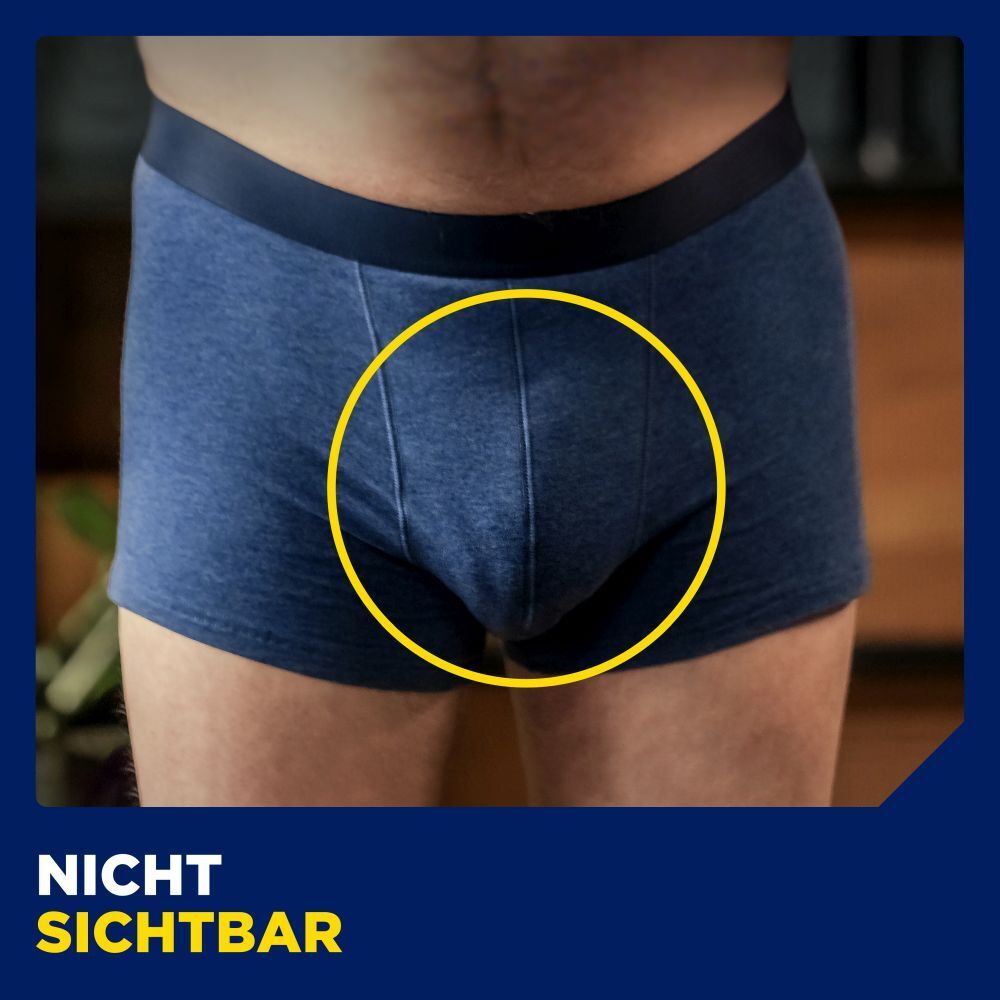 Nahaufnahme einer blauen Boxershorts. Gelber Kreis um den Schritt. Text: Nicht sichtbar.