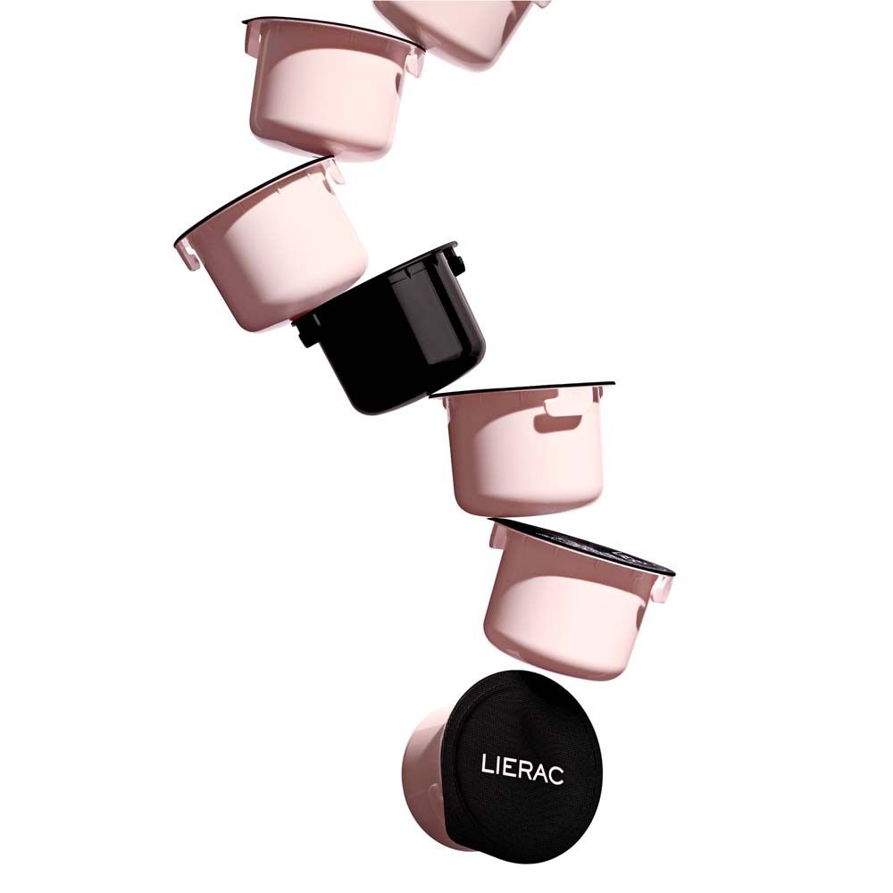 Mehrere rosa Nachfüllpackungen und ein schwarzer Deckel. Einige mit Deckel, andere ohne.