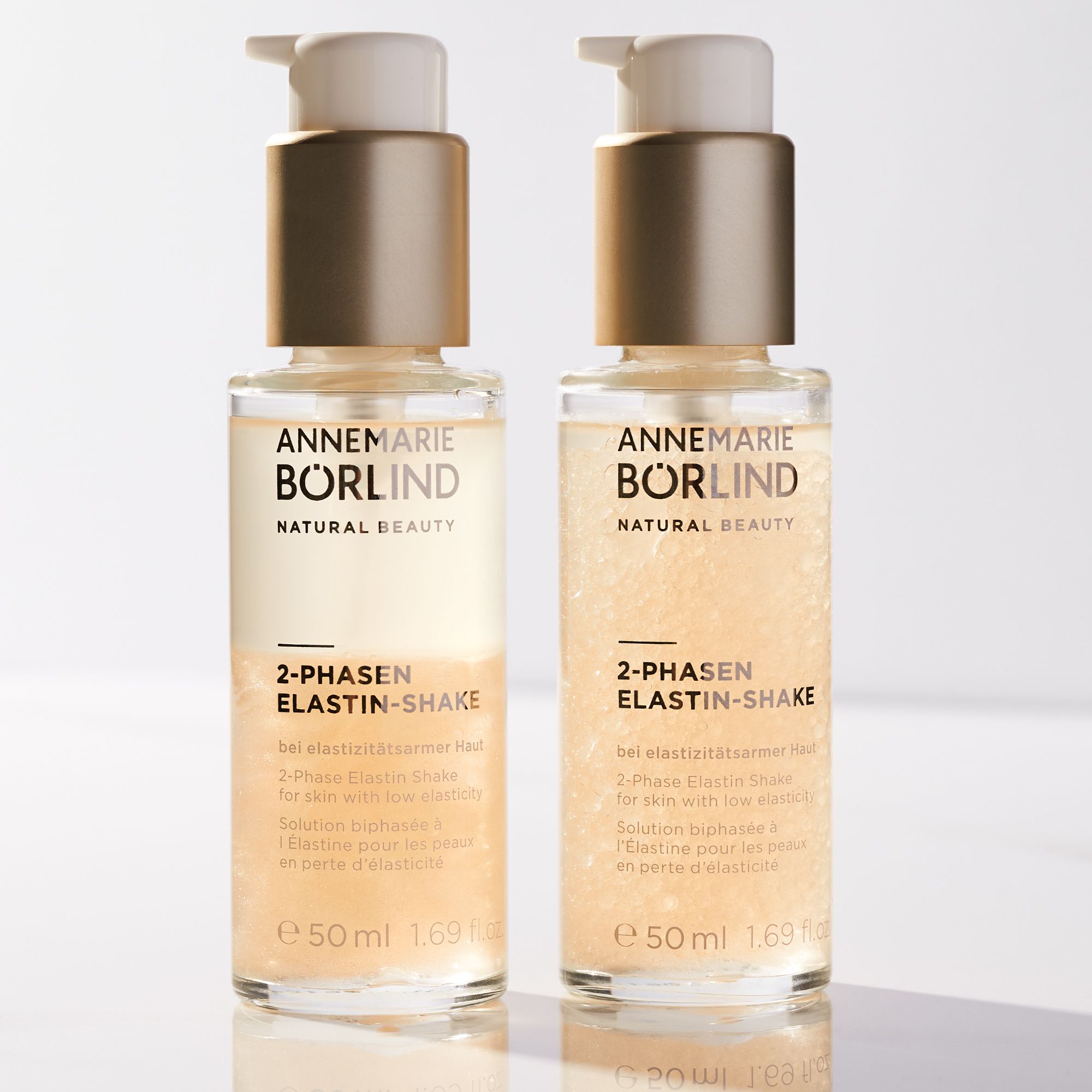 Zwei Flaschen ANNEMARIE BÖRLIND 2-Phasen Elastin Shake. Flaschen mit Pumpe. Zwei-Phasen-Flüssigkeit. Text.