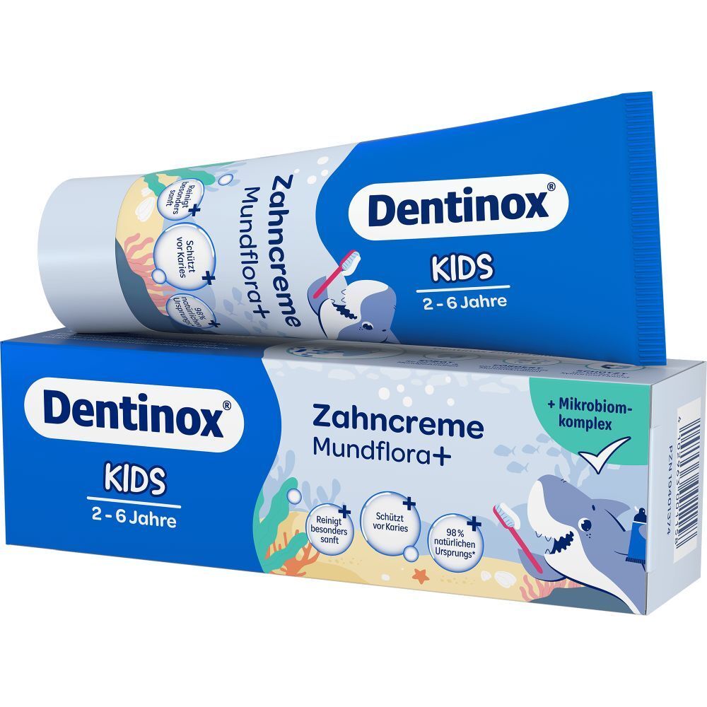 Zahncreme-Tube und -Karton. Blau, mit "Dentinox KIDS" und "Zahncreme Mundflora+". Tube auf Karton.