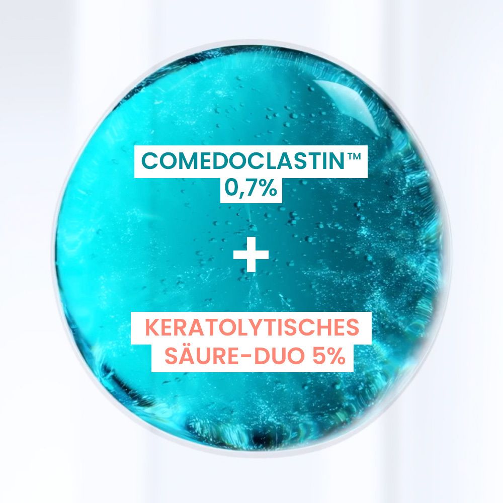 Nahaufnahme eines blauen Kreises mit Text: Comedoclastin 0,7% + Keratolytisches Säure-Duo 5%.