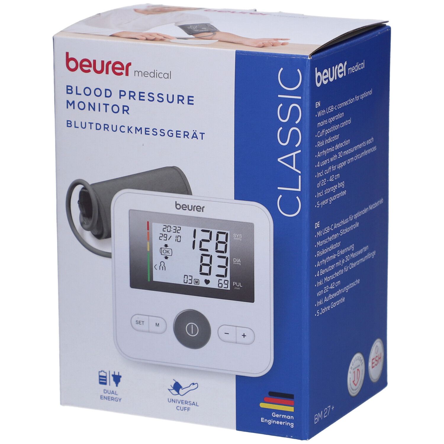 Blutdruckmessgerät in Verpackung. Weißes Gerät mit Display, Manschette, Logo. Text: Beurer, Blutdruckmessgerät, Classic.
