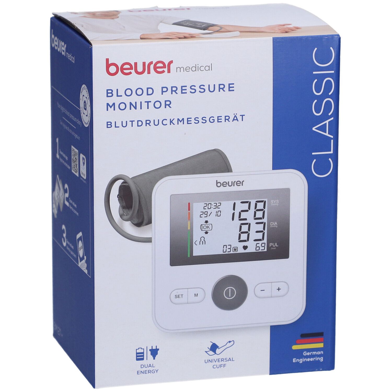 Blutdruckmessgerät in Verpackung. Weißes Gerät mit Display, Manschette, Logo. Text: Beurer, Blutdruckmessgerät, Classic.