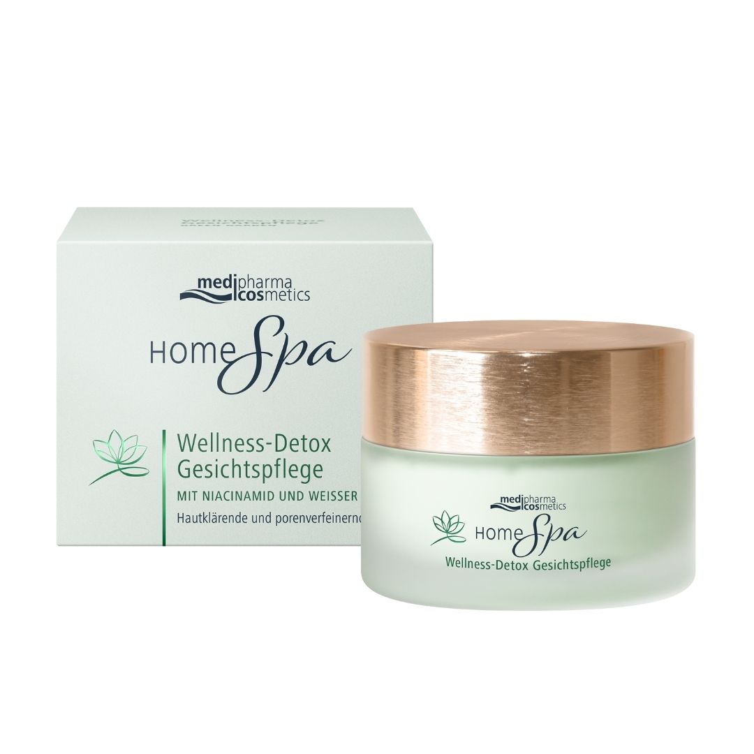 Creme-Tiegel mit Deckel und Verpackung. Aufschrift: Home Spa Wellness-Detox Gesichtspflege.