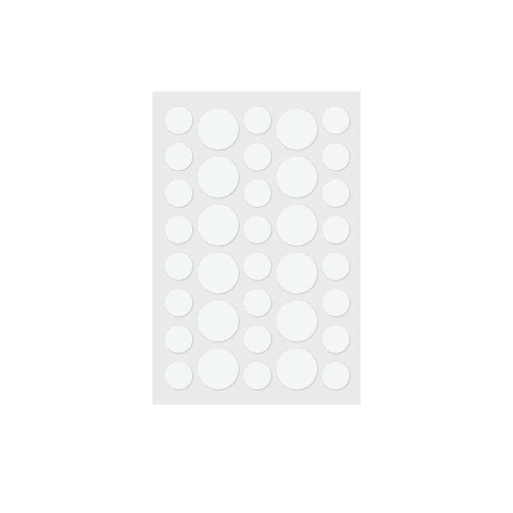 Blatt mit runden, weißen UV-Indikator-Aufklebern. Mehrere Größen. Aufkleber zur Erkennung unzureichenden Sonnenschutzes.