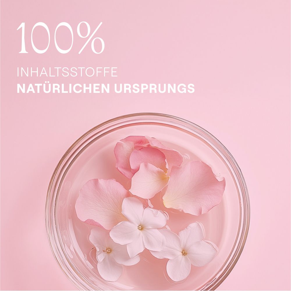 Schüssel mit Wasser, Rosenblättern und Blüten. Text: "100% INHALTSSTOFFE NATÜRLICHEN URSPRUNGS".