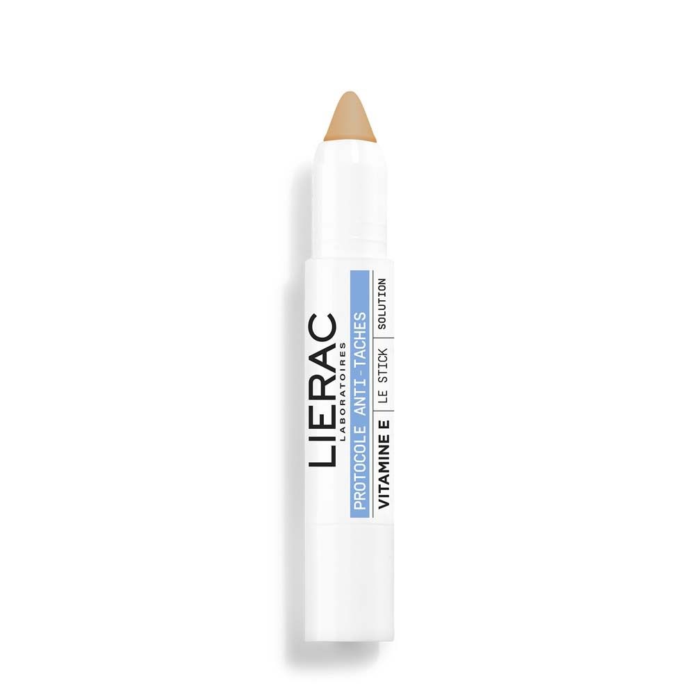 Weißer Stick mit beigefarbener Spitze. LIERAC-Logo und Produktinformationen: Protocole Anti-Taches, Vitamin E, Le Stick Solution.