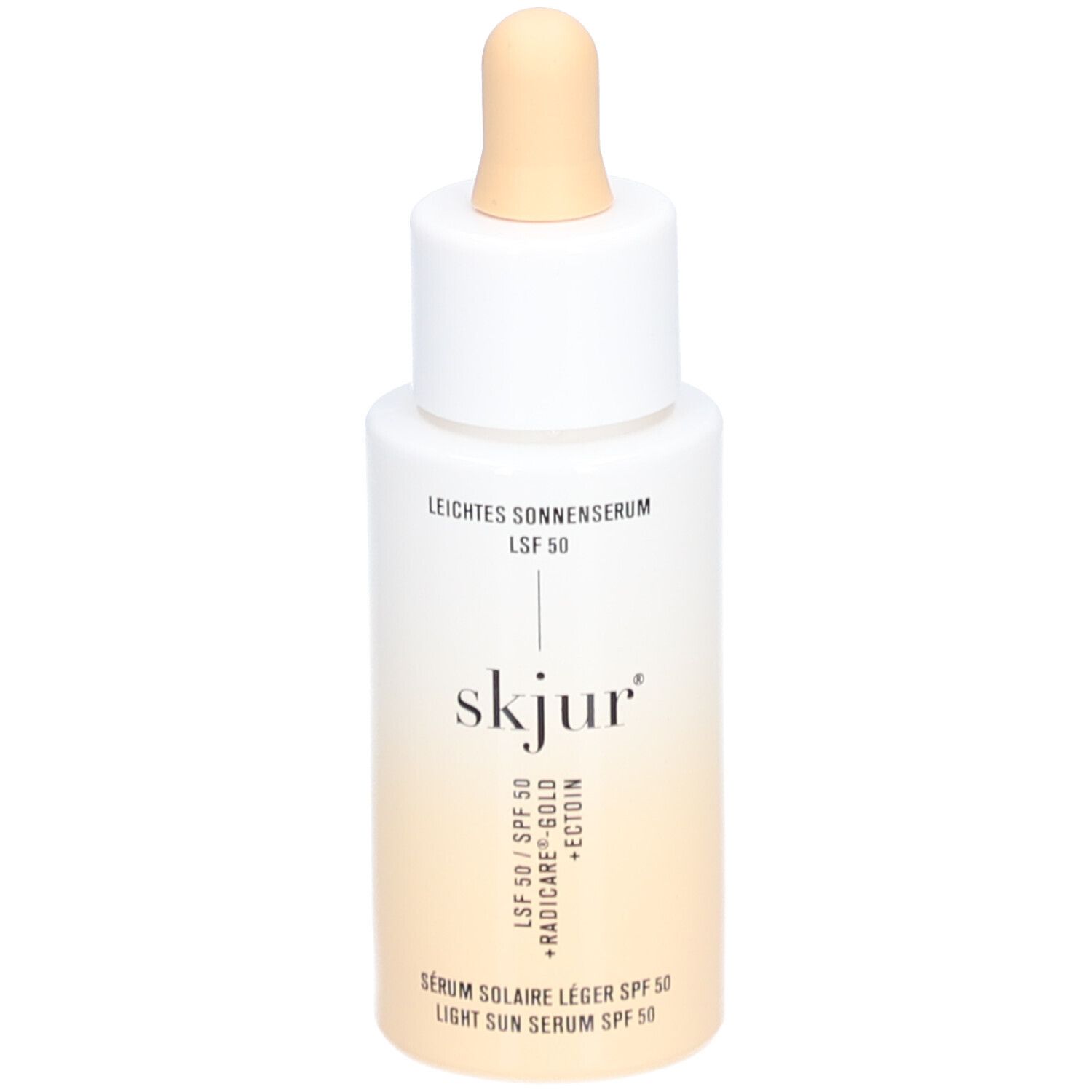 Weiß-beige Flasche mit Pipette. Aufschrift: Leichtes Sonnenserum LSF 50, skjur, Serum solaire léger SPF 50, Light Sun Serum SPF 50.