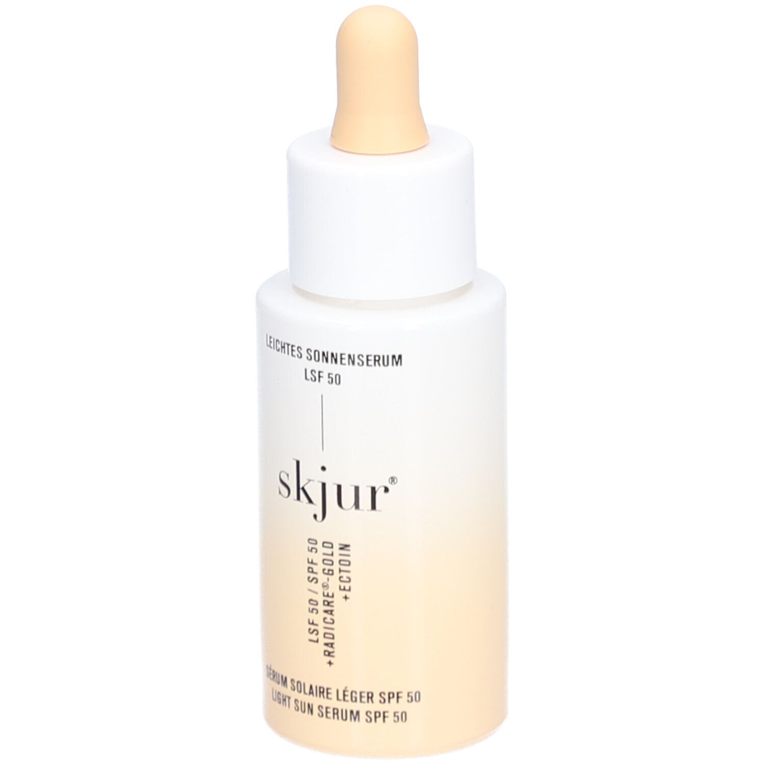 Weiß-beige Flasche mit Pipette. Aufschrift: Leichtes Sonnenserum LSF 50, skjur, Serum solaire léger SPF 50, Light Sun Serum SPF 50.