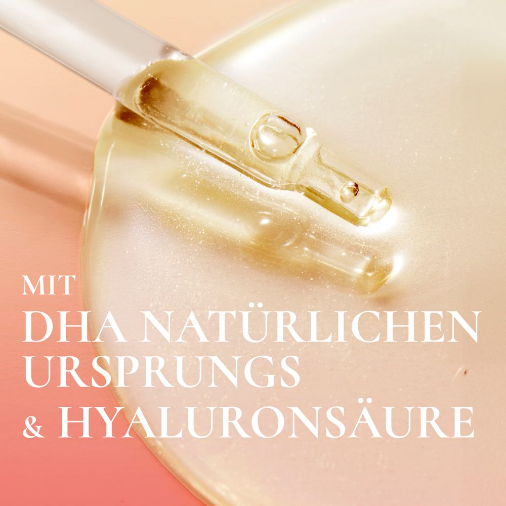 Pipette mit Serum auf heller Oberfläche. Text: Mit DHA natürlichen Ursprungs & Hyaluronsäure.
