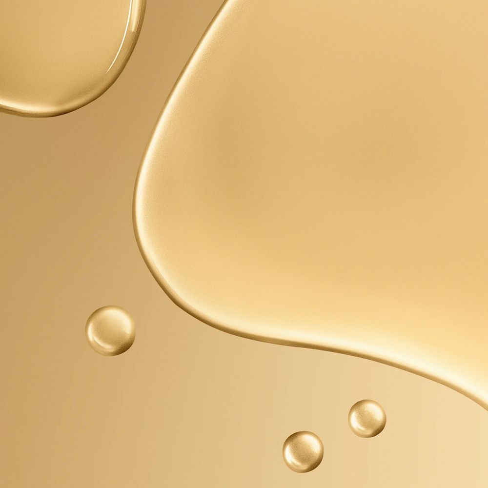 Goldene Flüssigkeitstropfen. Hintergrund. Nahaufnahme.