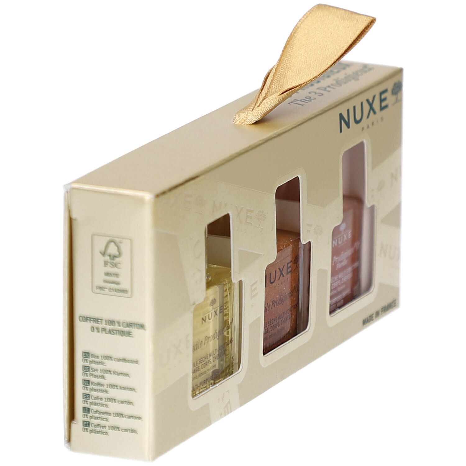 Goldfarbene Geschenkbox mit drei Sichtfenstern. FSC-Logo und Text über Verpackungsmaterialien. NUXE-Logo.