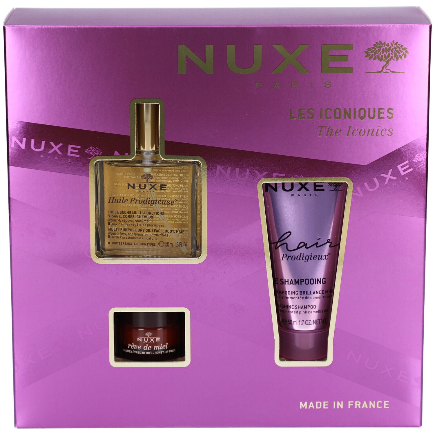 Geschenkset mit drei Produkten in einer lila Schachtel. Sichtbar sind ein Öl, ein Shampoo und eine Creme. Der Markenname NUXE ist sichtbar.