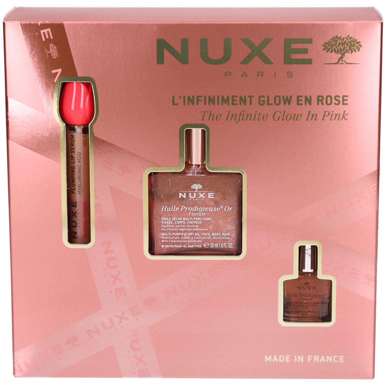 Geschenkset mit drei Produkten in rosa Verpackung. Enthält eine Flasche, eine kleine Flasche und einen Applikator. Marke NUXE.