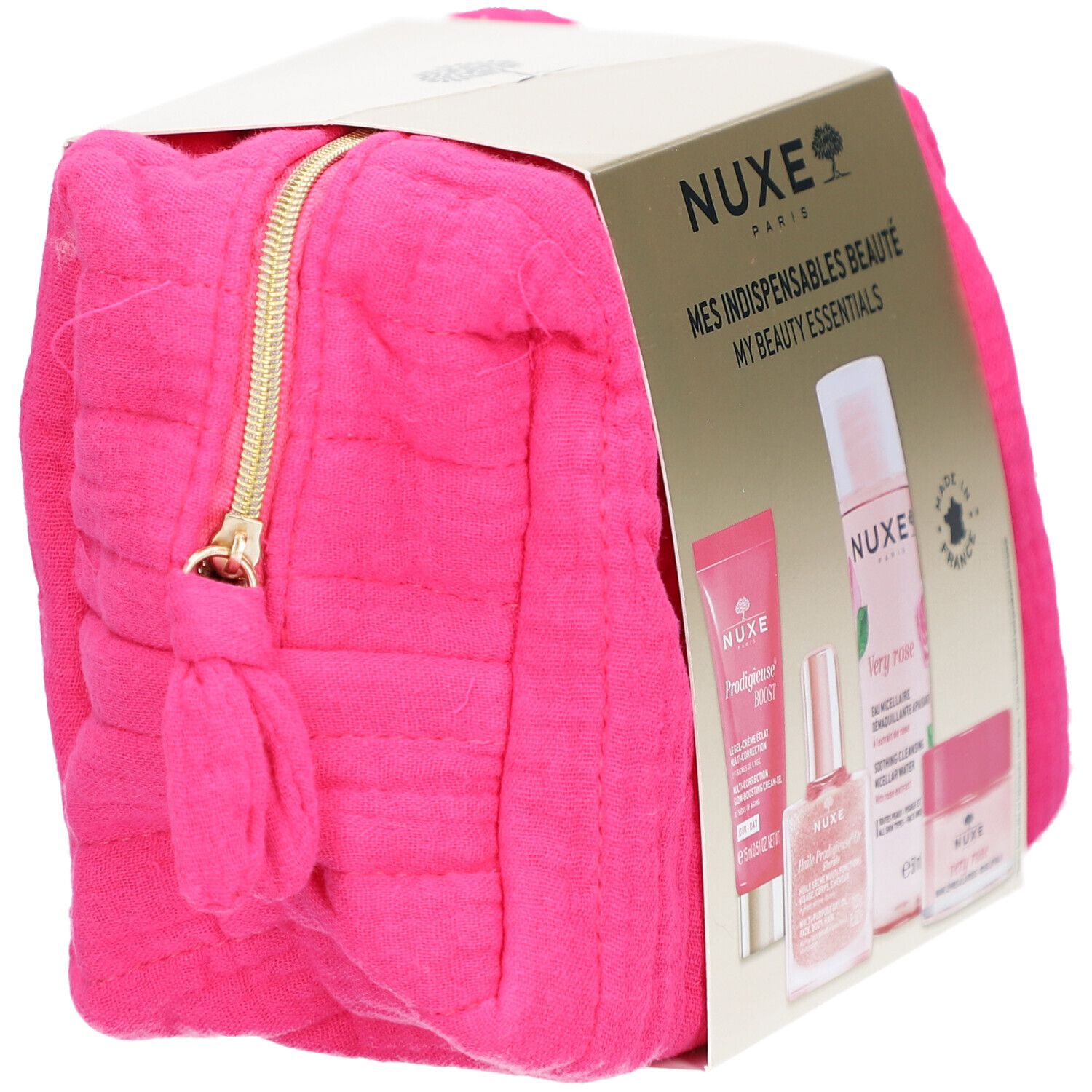 Pinkfarbene Kosmetiktasche mit goldfarbenem Reißverschluss und NUXE-Produktverpackung. Ansicht schräg.