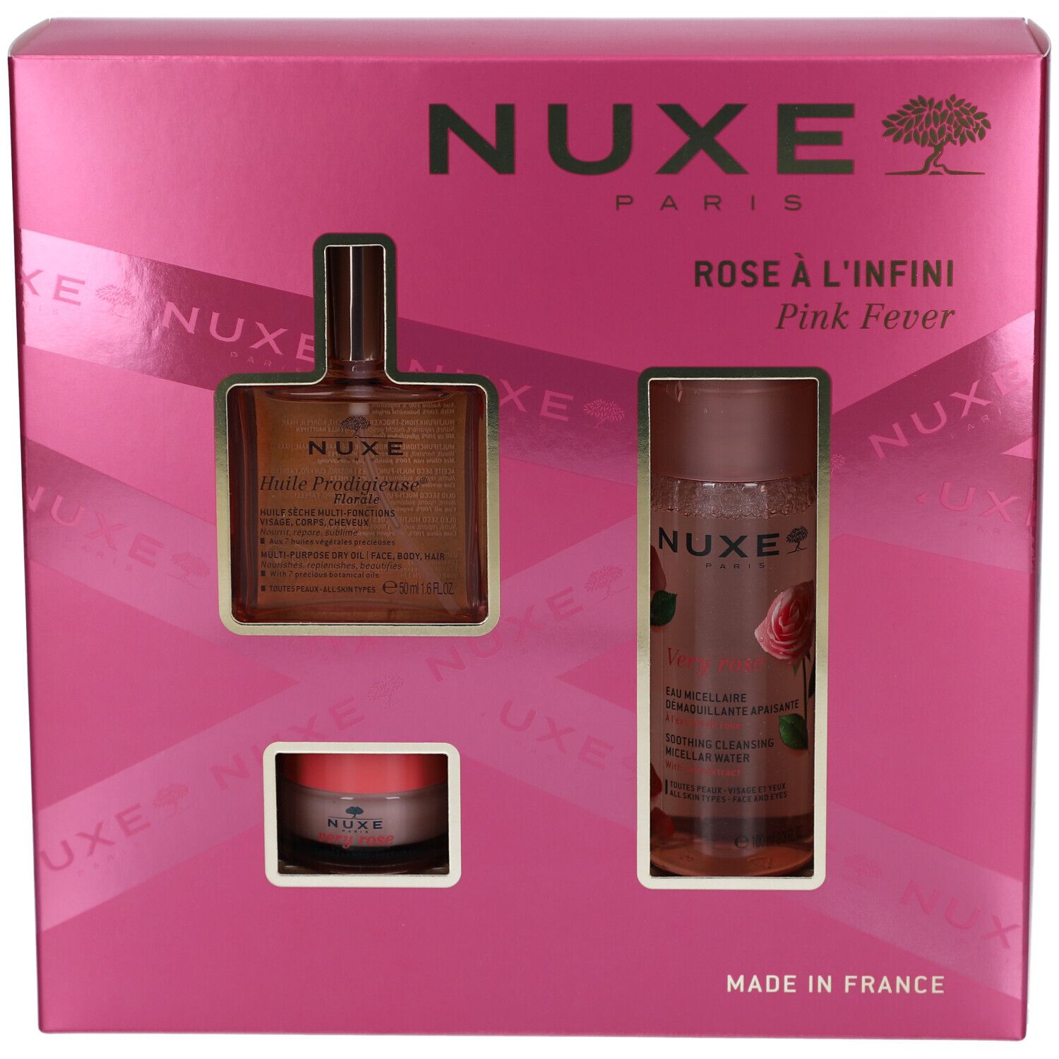 Rosa Geschenkset mit drei Produkten in einer pinken Schachtel. Sichtbar: Flasche, Tiegel und Sprayflasche. NUXE-Logo.