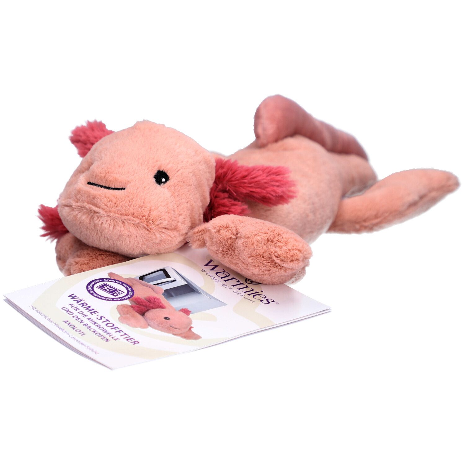 Rosa Axolotl-Wärmestofftier mit rotem Kiemenansatz. Liegt neben einer Broschüre mit Produktabbildung.