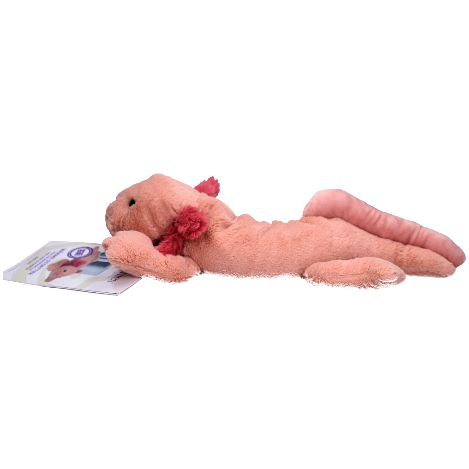 Rosa Axolotl-Wärmestofftier mit rotem Kiemenansatz liegt neben einer Broschüre.