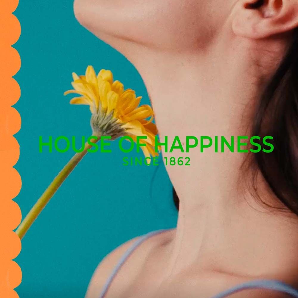 Gelbe Blume. Text: HOUSE OF HAPPINESS SINCE 1862.