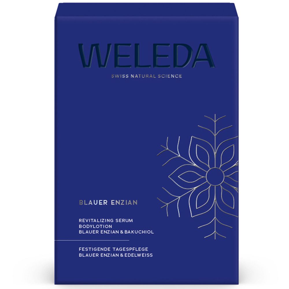 Blaue Geschenkbox mit Logo und Produktnamen. Text: Blauer Enzian, Serum Bodylotion, Tagespflege. Schneeflocken-Design.