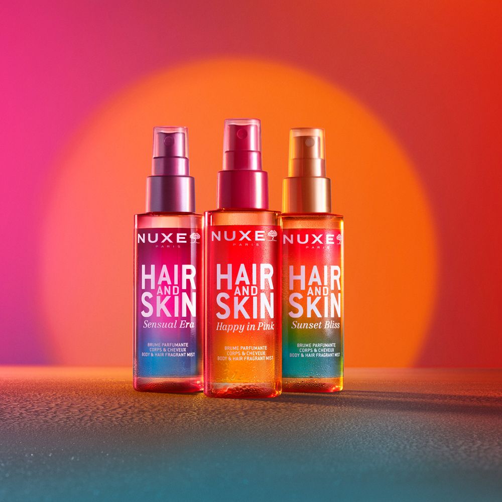 Drei NUXE® Hair and Skin Sprays. Text: Hair and Skin, Sensual Era, Happy in Pink, Sunset Bliss.