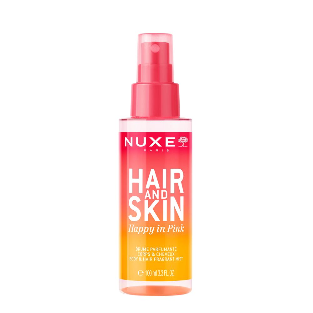NUXE® Happy In Pink Duftspray. Rosa Flasche mit Sprühkopf. Schriftzug: Hair and Skin, Happy in Pink. Orange-gelber Farbverlauf.