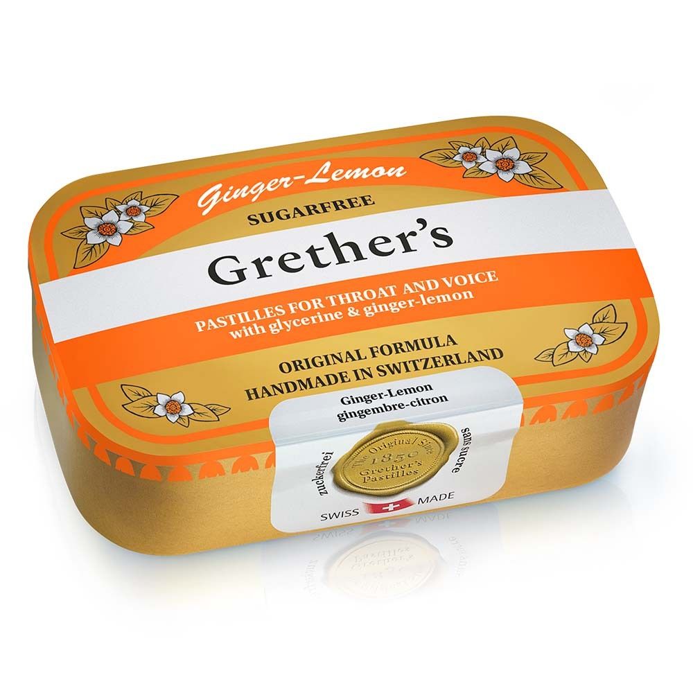 Goldene Dose mit Grether's Pastilles Ginger Lemon. Weißer Streifen mit Produktnamen. Blüten-Dekor. Schweizer Qualitätssiegel.