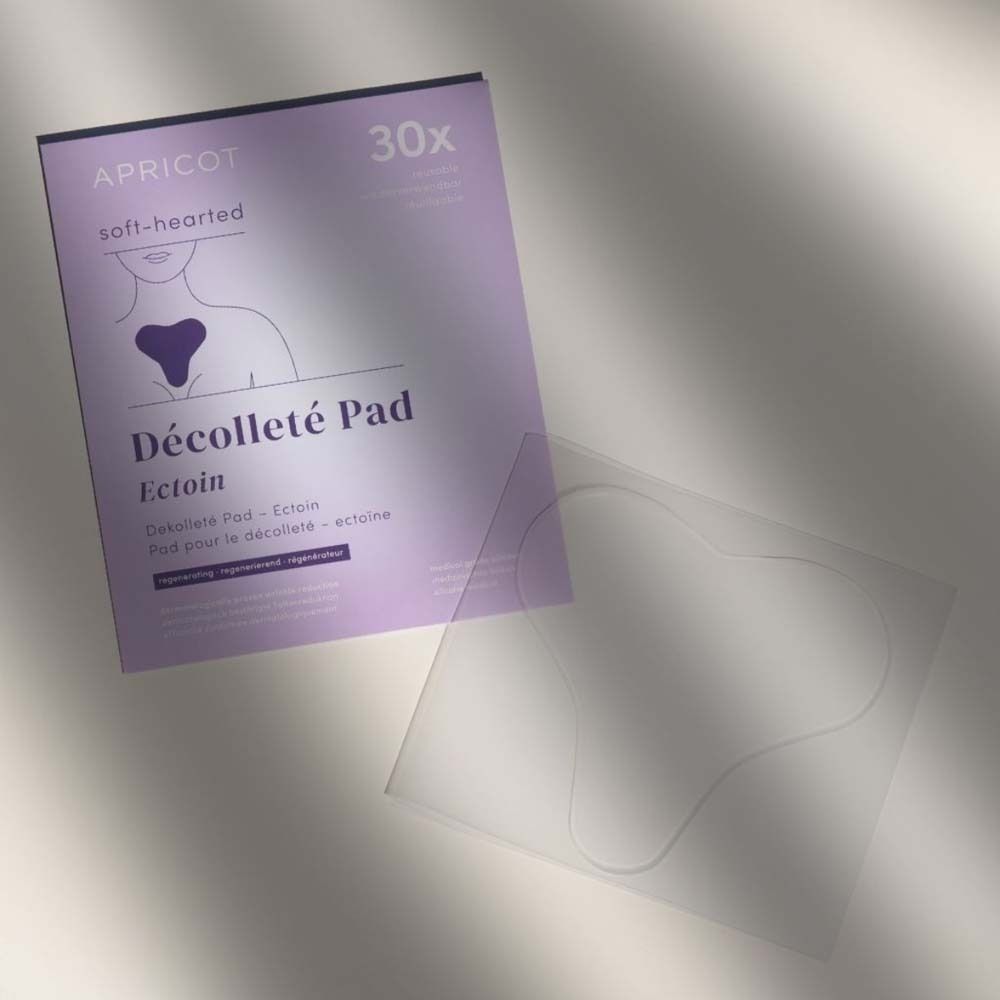 Verpackung und transparentes Dekolleté Pad. Aufdruck: APRICOT, Décolleté Pad, Ectoin.