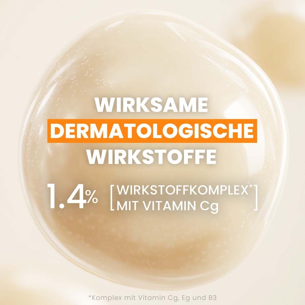 Nahaufnahme einer Flüssigkeit. Text: Wirksame dermatologische Wirkstoffe, 1.4% [Wirkstoffkomplex] mit Vitamin Cg.