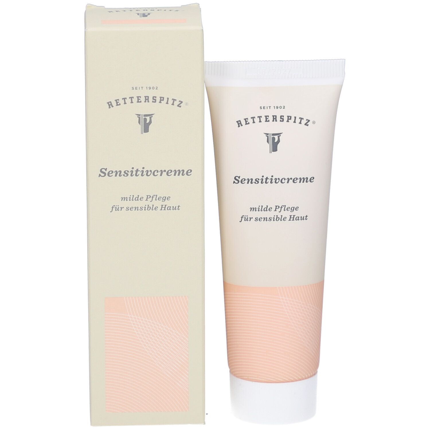 Produktverpackung mit Tube und Karton. Beide zeigen Produktnamen und Logo. Farbgebung: Weiß, Beige und Rosa.