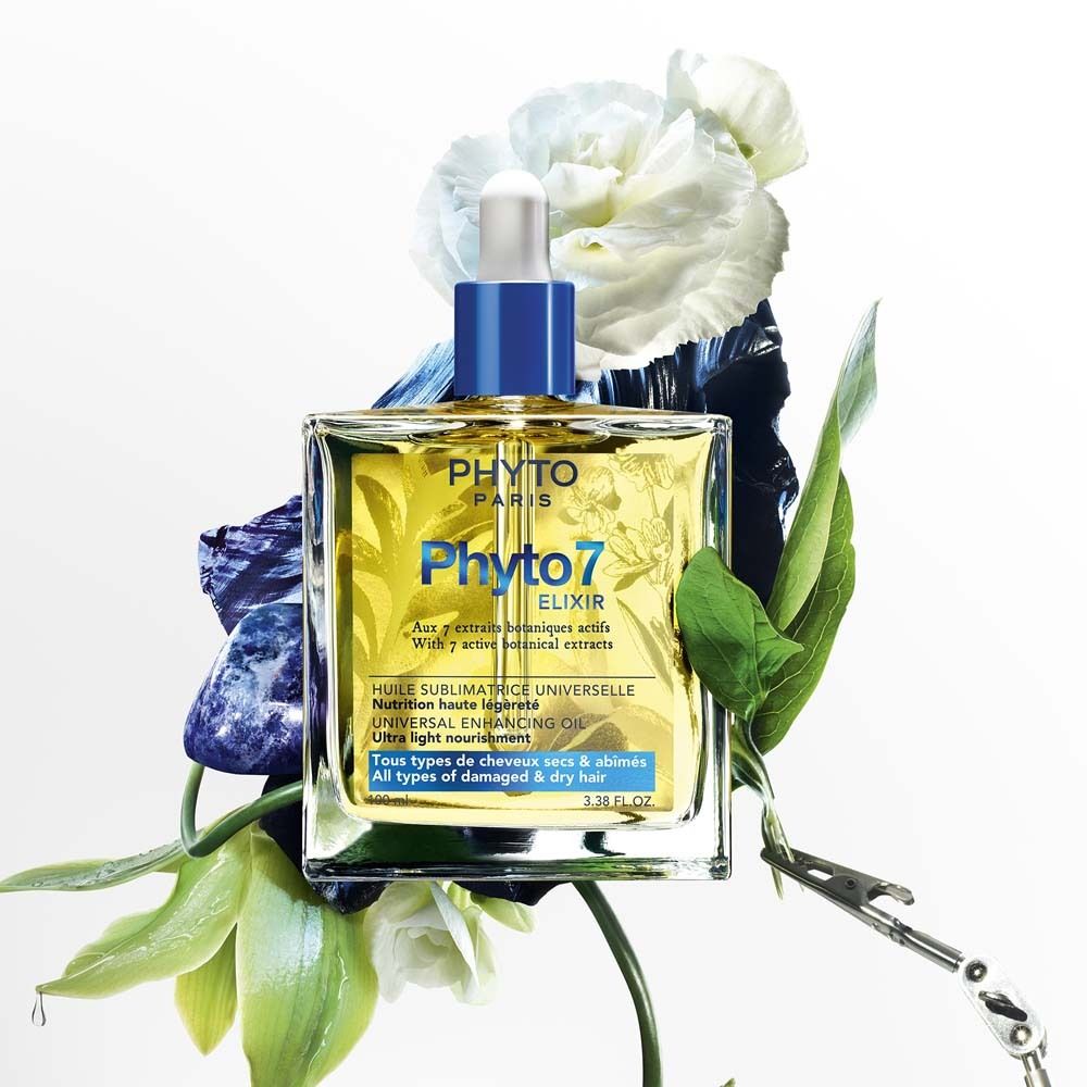 Produktabbildung: Phyto 7 Elixir. Flasche umgeben von Blumen und Blättern. Blaue Kappe und Pipette.