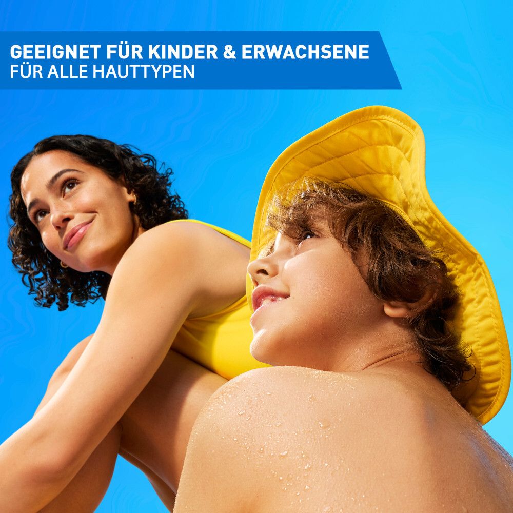 Mutter und Kind im Sonnenschein. Text: Geeignet für Kinder & Erwachsene. Für alle Hauttypen. Gelber Hut.