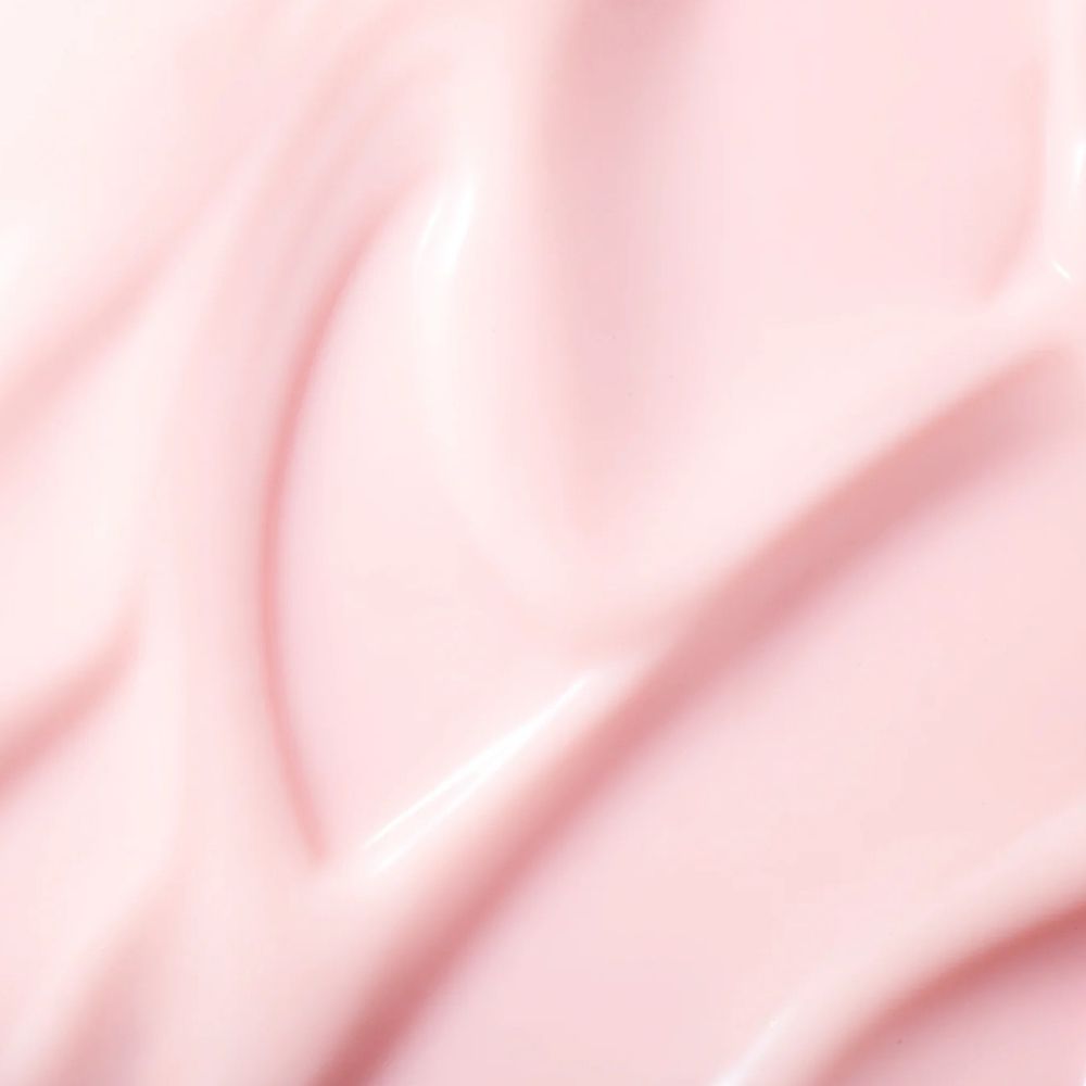 Nahaufnahme von rosa Creme. Wellenförmige Textur.
