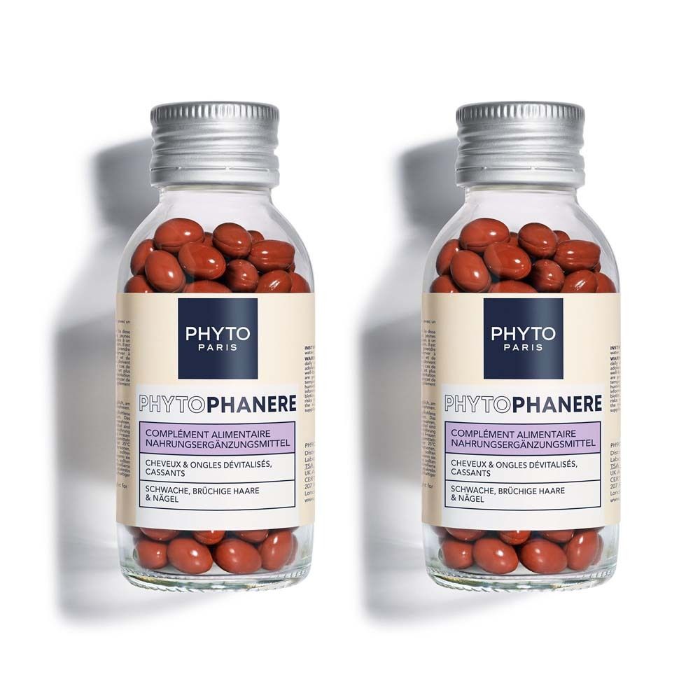 Zwei Flaschen mit roten Kapseln. Aufschrift: PHYTO PARIS Phytophanère. Nahrungsergänzungsmittel für Haare & Nägel. Glasflaschen mit silbernen Deckeln.