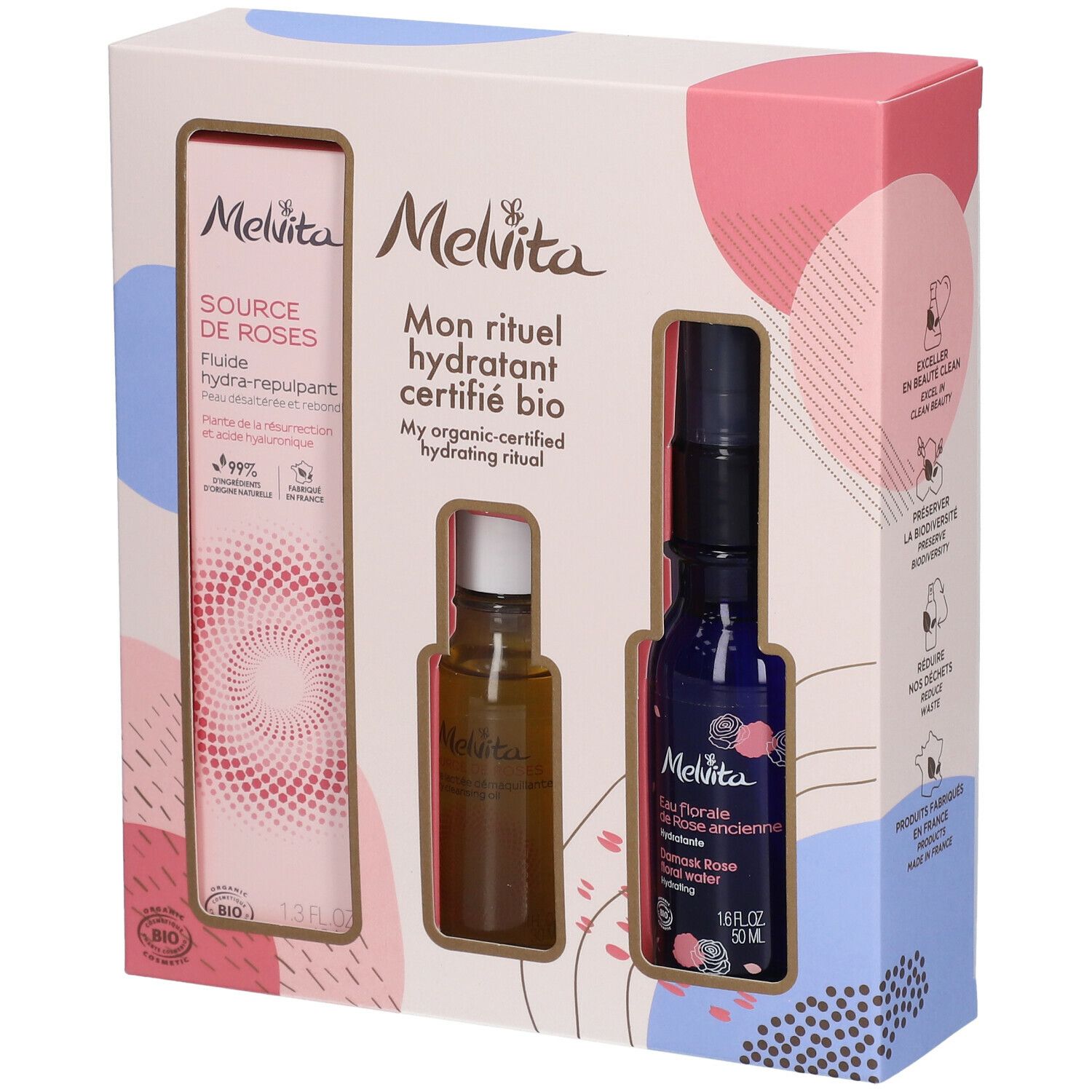 Geschenkbox mit drei Produkten. Links: Flasche mit Flüssigkeit. Mitte: kleine Flasche. Rechts: blaue Flasche mit Sprühkopf.