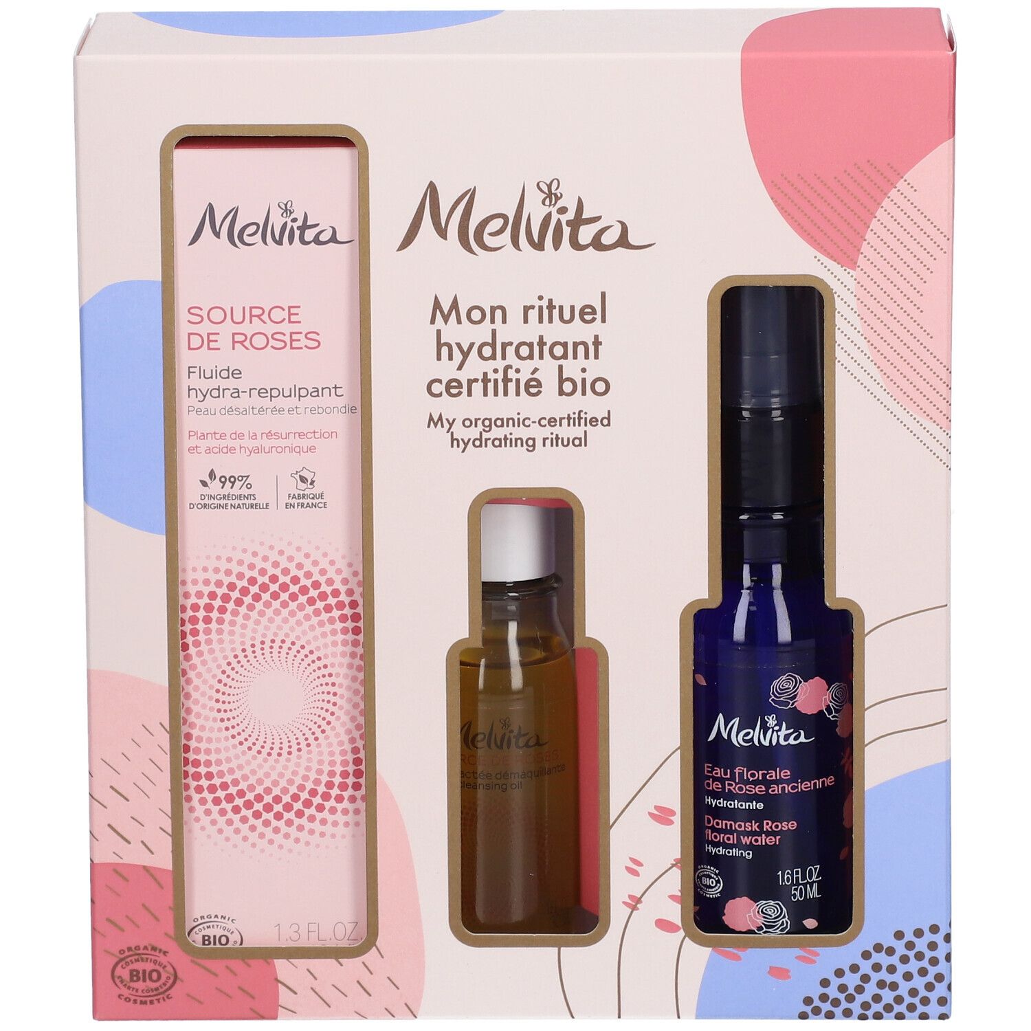 Geschenkbox mit drei Produkten. Links: Flasche mit Flüssigkeit. Mitte: kleine Flasche. Rechts: blaue Flasche mit Sprühkopf.