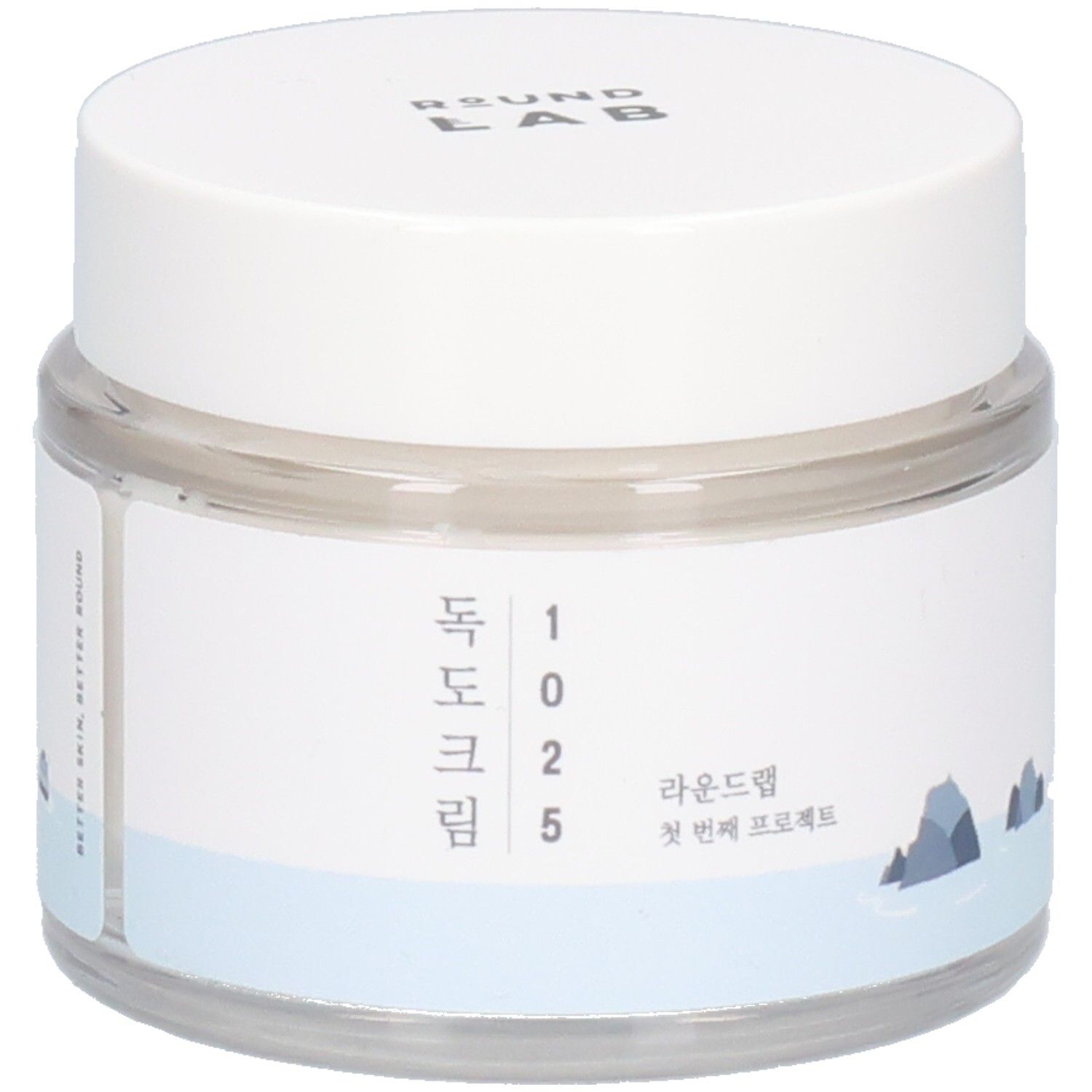 Runde, transparente Dose mit weißem Deckel. Aufkleber mit koreanischem Text und Logo. "ROUND LAB" oben.