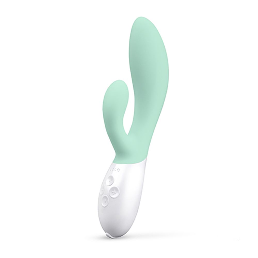 Mintfarbener Vibrator mit weißem Sockel. Drei Knöpfe. Form: gebogen, mit zwei Enden.