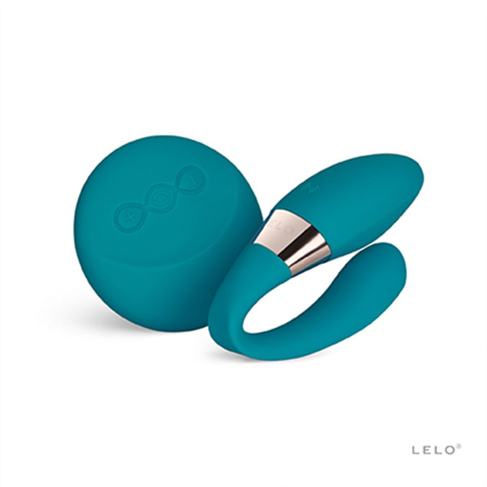 Blauer Stimulator mit runder Basis und gebogener Spitze. Metallakzente. LELO-Logo.