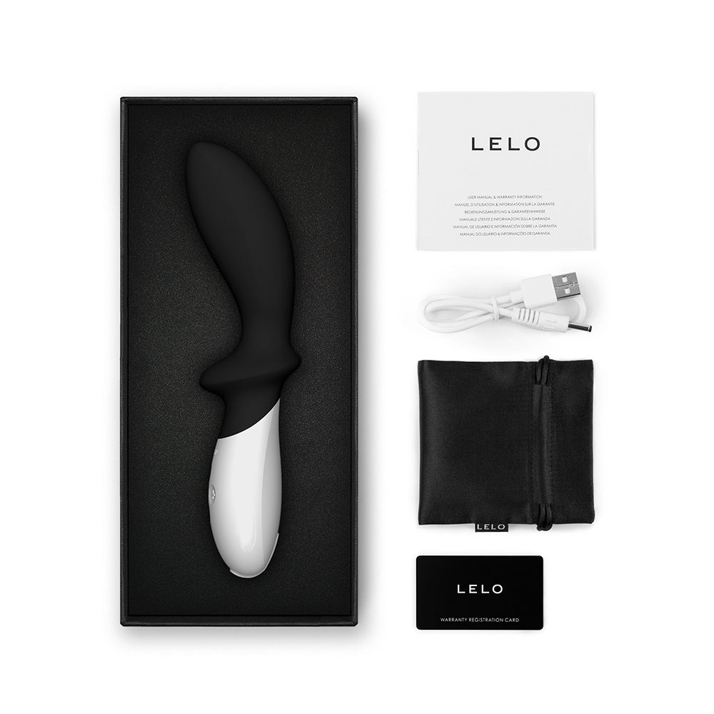 Produktverpackung mit Massagegerät, Ladekabel, Beutel, Garantiekarte und Broschüre. LELO-Logo.