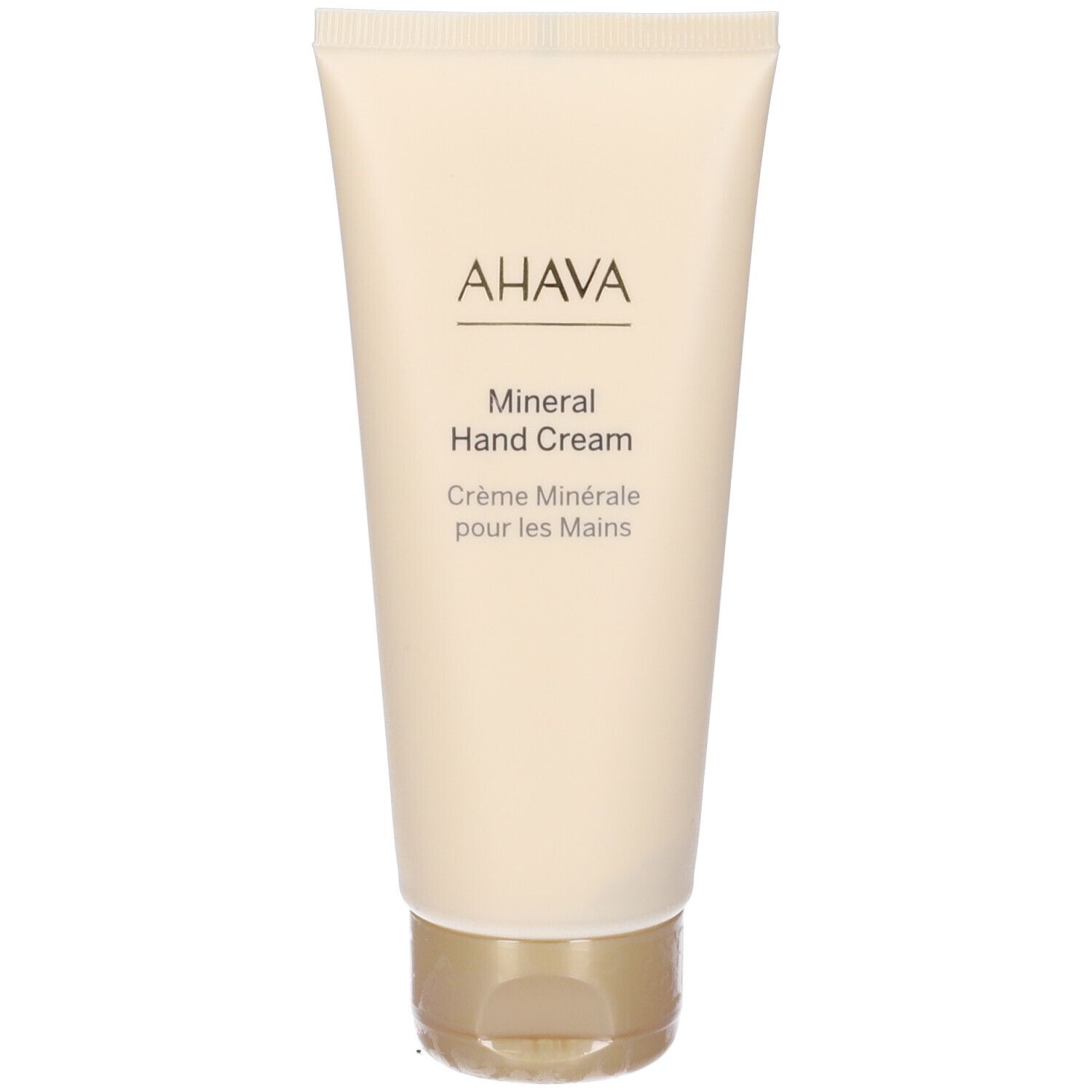 Creme-Tube mit AHAVA-Logo und Schriftzug Mineral Hand Cream. Beige Tube mit goldenem Verschluss.