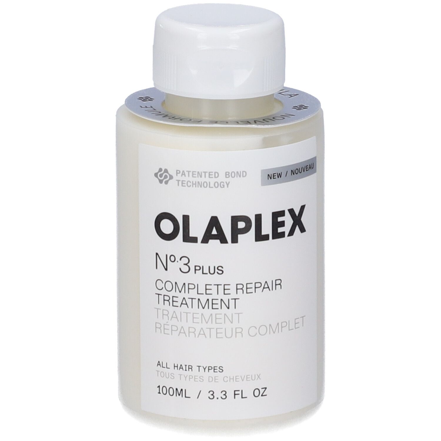 Beige Flasche mit weißem Deckel. Aufschrift: OLAPLEX N°3 PLUS COMPLETE REPAIR TREATMENT. Aufkleber mit Text und Logo.