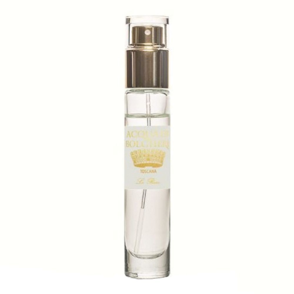 Klare Glasflasche mit goldenem Sprühkopf und Etikett mit Krone und Schriftzug.