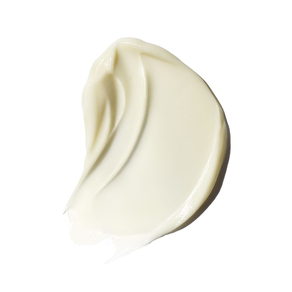 Nahaufnahme einer Creme-Textur. Cremefarbene, gewellte Spur auf weißem Hintergrund.