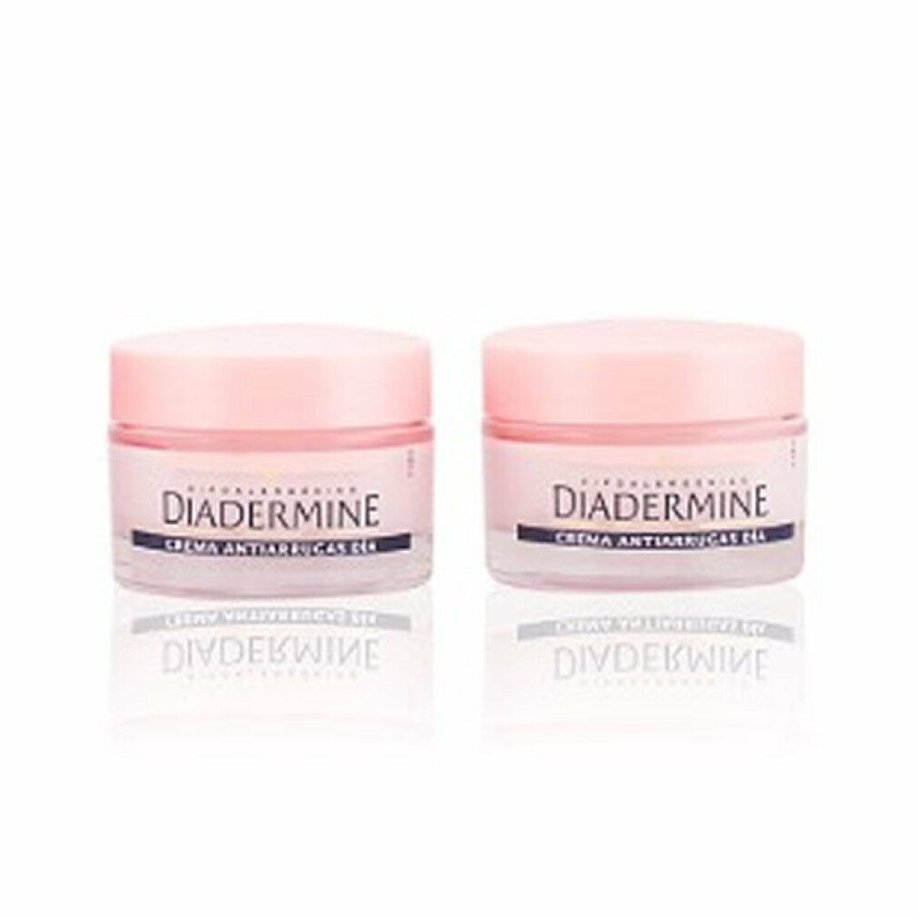 Zwei Tiegel Diadermine Creme. Aufschrift: Creme Anti-Falten. Rosa Deckel, transparente Gläser.