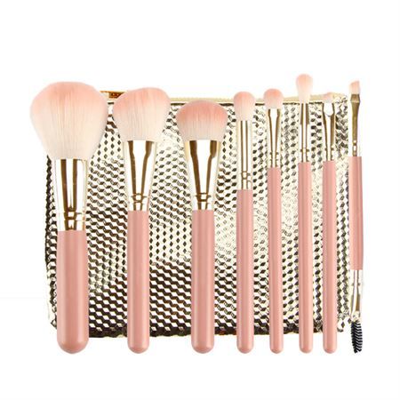 Set mit acht rosa Make-up-Pinseln mit goldenen Applikationen und einem goldenen Etui.