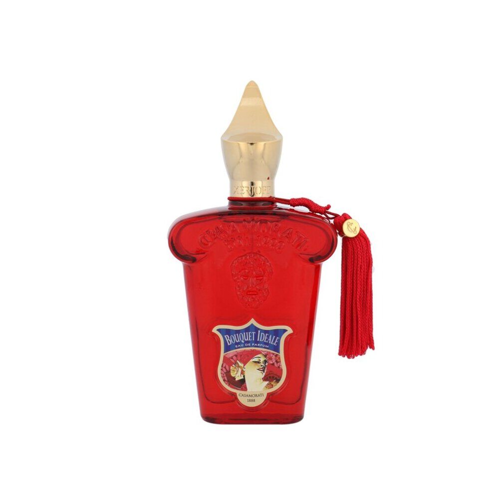 Roter Flakon mit goldfarbenem Verschluss und Quaste. Aufkleber mit floralem Motiv und Schriftzug.