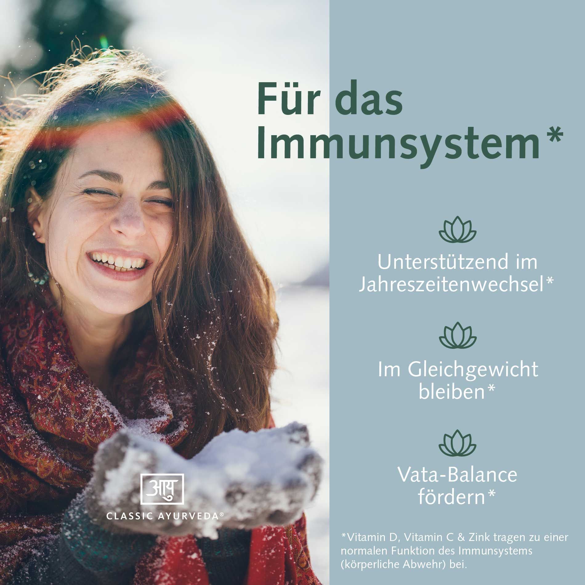 Lächelnde Frau im Schnee, die sich die Hände voller Schnee hält. Text: Für das Immunsystem.